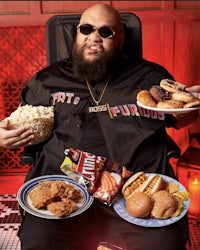 a man sitting in a chair with a plate of food