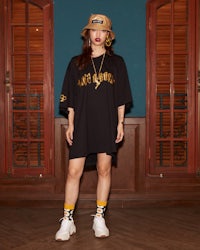 a woman wearing a black t - shirt and yellow socks