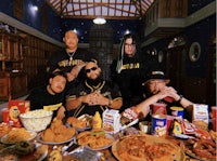 a group of people sitting around a table with food
