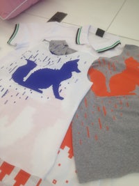 two t - shirts with a cat on them